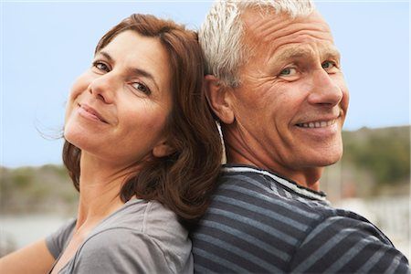 Mature Couple Sitting Back To Back